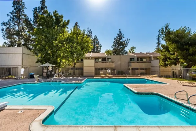 a aerial view of a house with swimming pool garden and outdoor seating