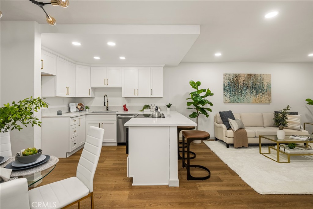3010 Associated Road, Unit 122 Fullerton, CA 92835 - Photo 2 of 17 a living room with kitchen island furniture and a potted plant