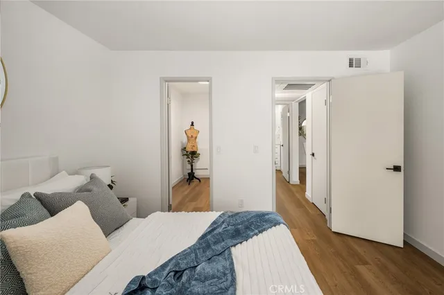 a bedroom with a bed and wooden floor