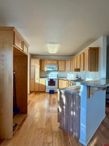a kitchen with granite countertop a stove and a wooden floors