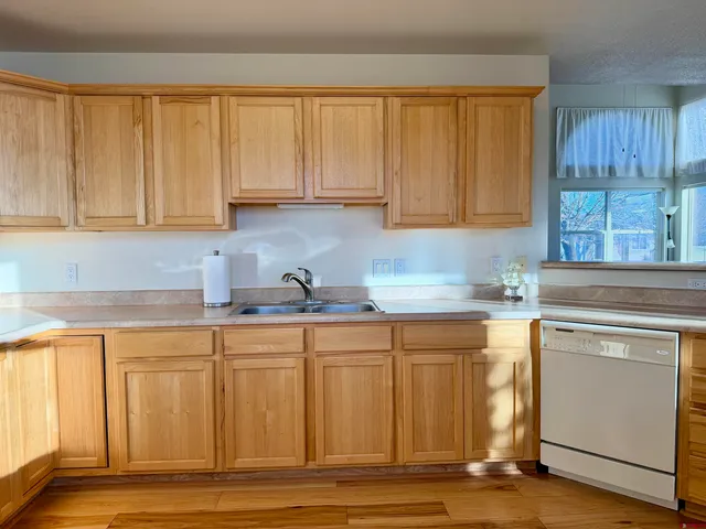 a kitchen with granite countertop a sink stainless steel appliances and cabinets