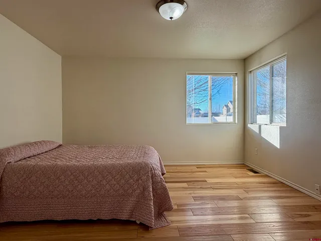 a bedroom with a bed and window