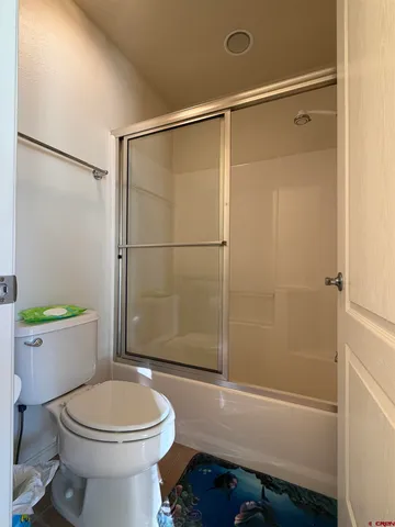 a bathroom with a toilet and a shower