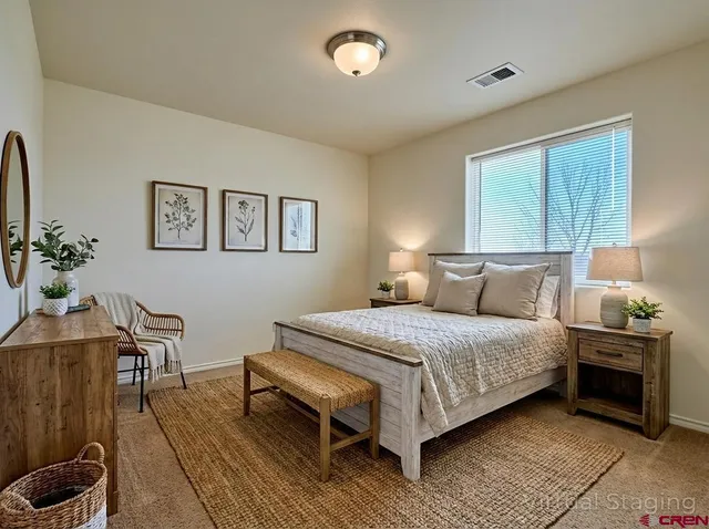 a bedroom with a bed and a table