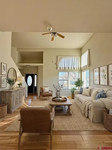 a living room with furniture a window and a clock