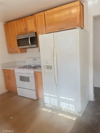 a kitchen with stainless steel appliances white cabinets and a refrigerator