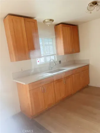 a kitchen with a sink a window and a cabinets