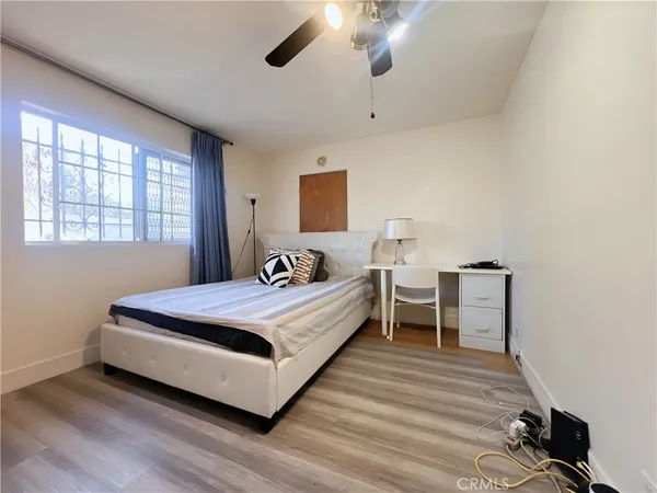 a spacious bedroom with a bed and a table