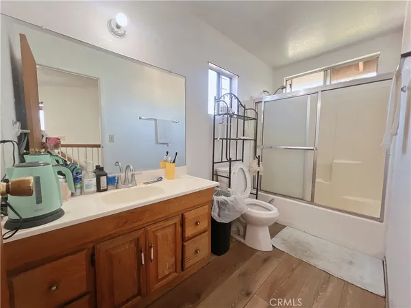 a bathroom with a double vanity sink toilet and shower