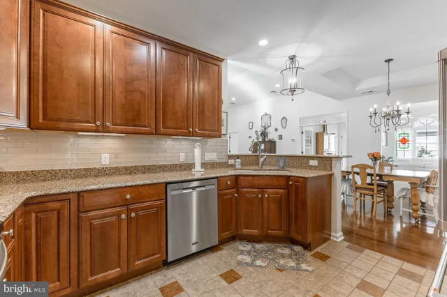 a kitchen with granite countertop cabinets sink and window