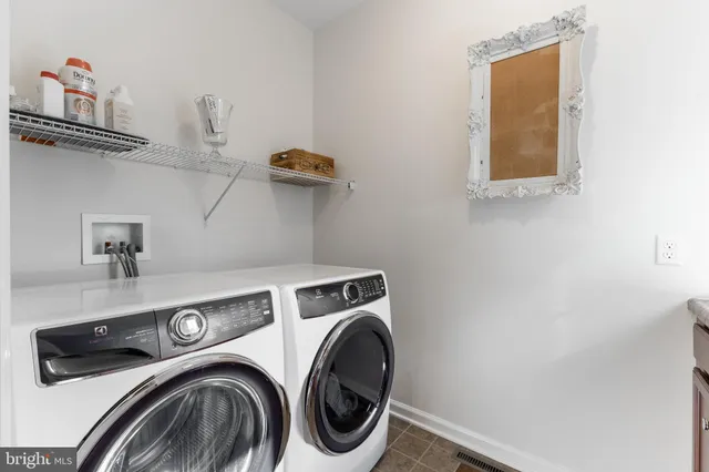 a dining room with furniture and a potted plant