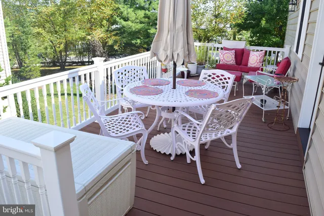 a front view of a house with yard and glass windows