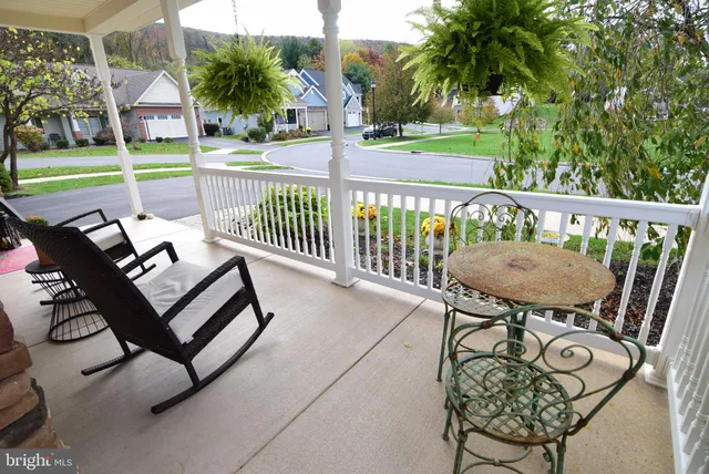 a view of a chairs and table in patio with a small yard