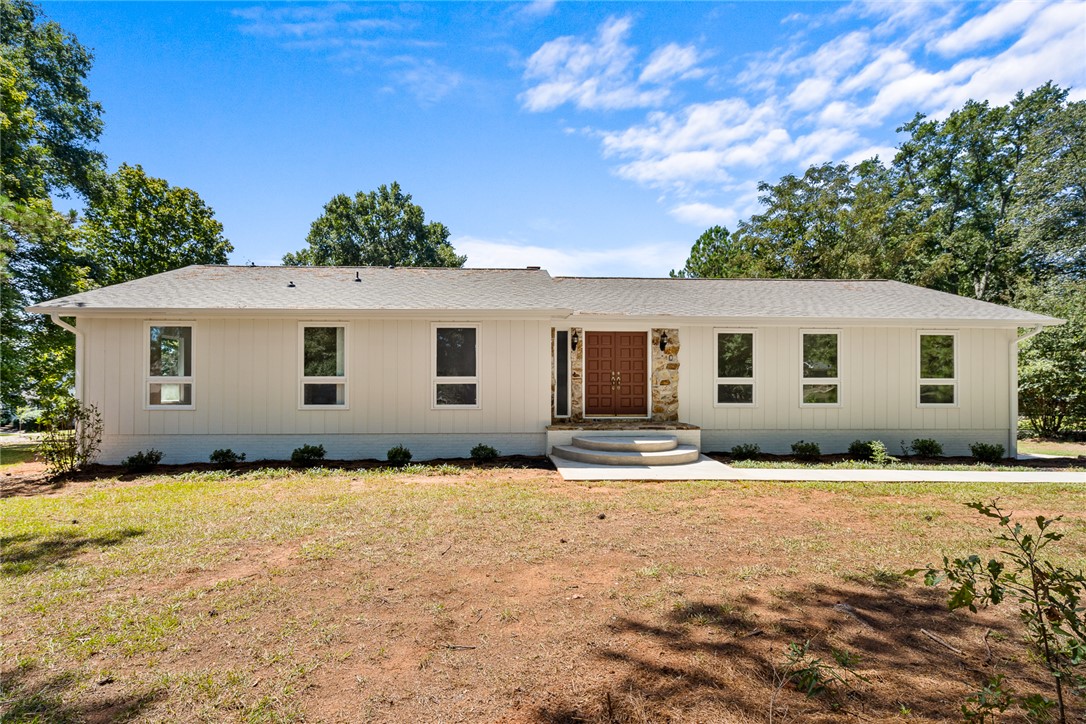 208 Williamsburg Road Anderson, SC 29621 - Photo 1 of 48 Board and batten siding pairs with stone accents on this single-story ranch exterior.