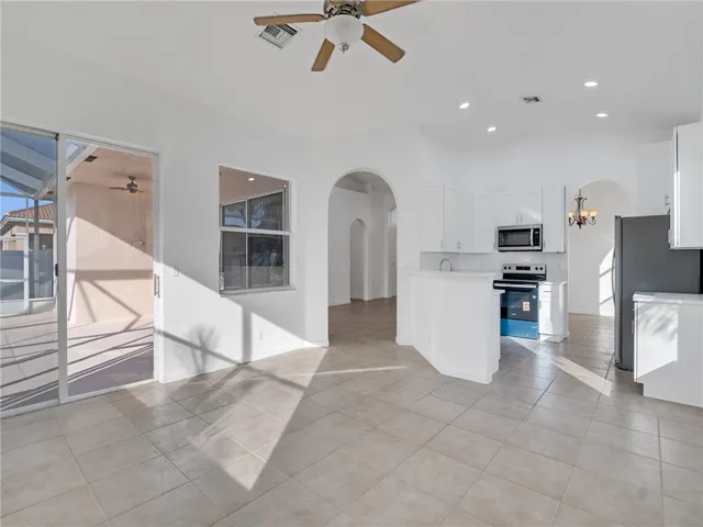 a view of kitchen with cabinets and refrigerator