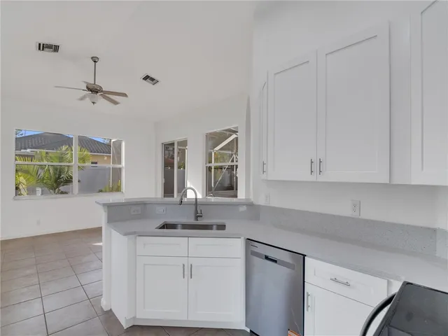 a kitchen with a sink cabinets and window
