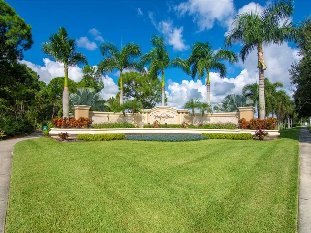 a view of a fountain in front of a house with a big yard