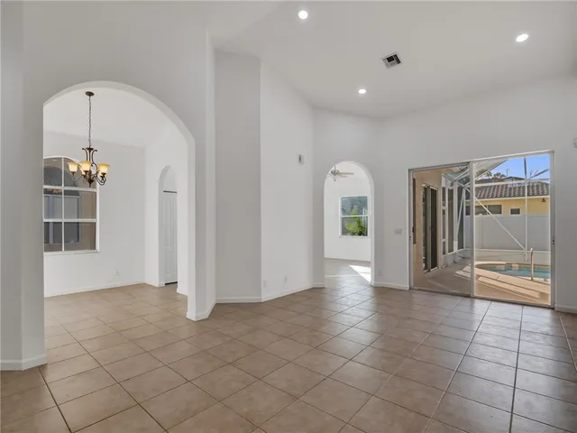 a view of a hallway with entryway and chandelier