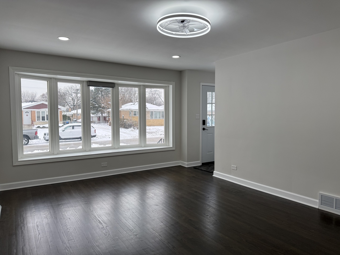 10061 Lacrosse Avenue Skokie, IL 60077 - Photo 2 of 19 an empty room with wooden floor and windows