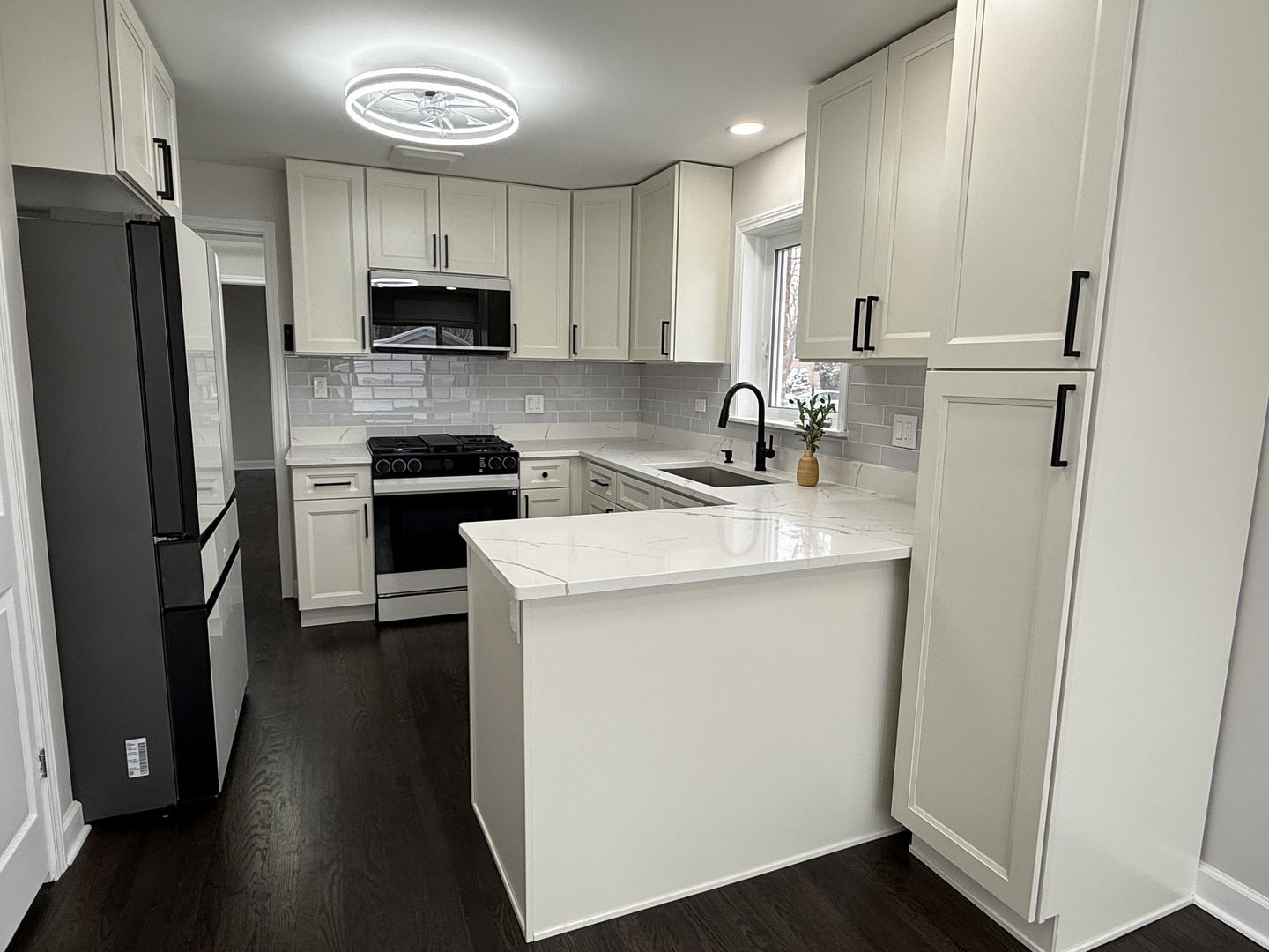 10061 Lacrosse Avenue Skokie, IL 60077 - Photo 3 of 19 a kitchen with a sink a refrigerator a microwave a sink and cabinets