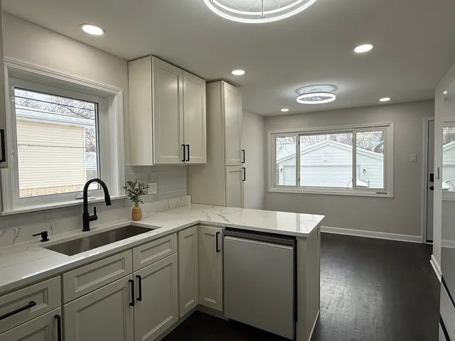 a kitchen with a sink cabinets and window