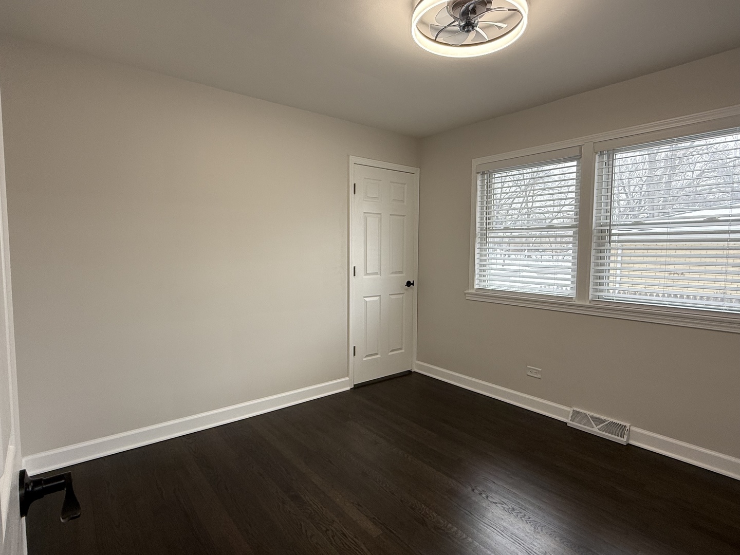 10061 Lacrosse Avenue Skokie, IL 60077 - Photo 6 of 19 a view of an empty room with wooden floor and a window