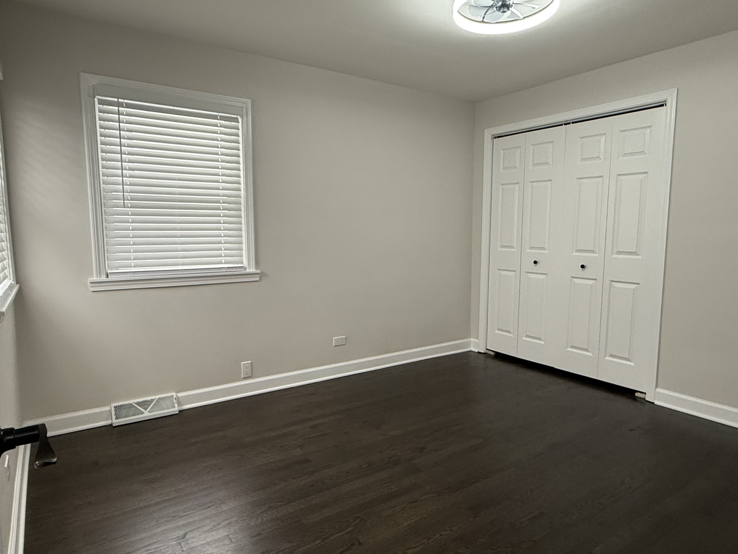 10061 Lacrosse Avenue Skokie, IL 60077 - Photo 7 of 19 a view of an empty room with wooden floor and a window