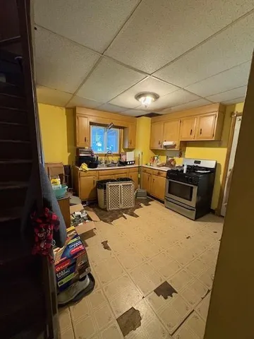 a kitchen with furniture a counter top space appliances and cabinets