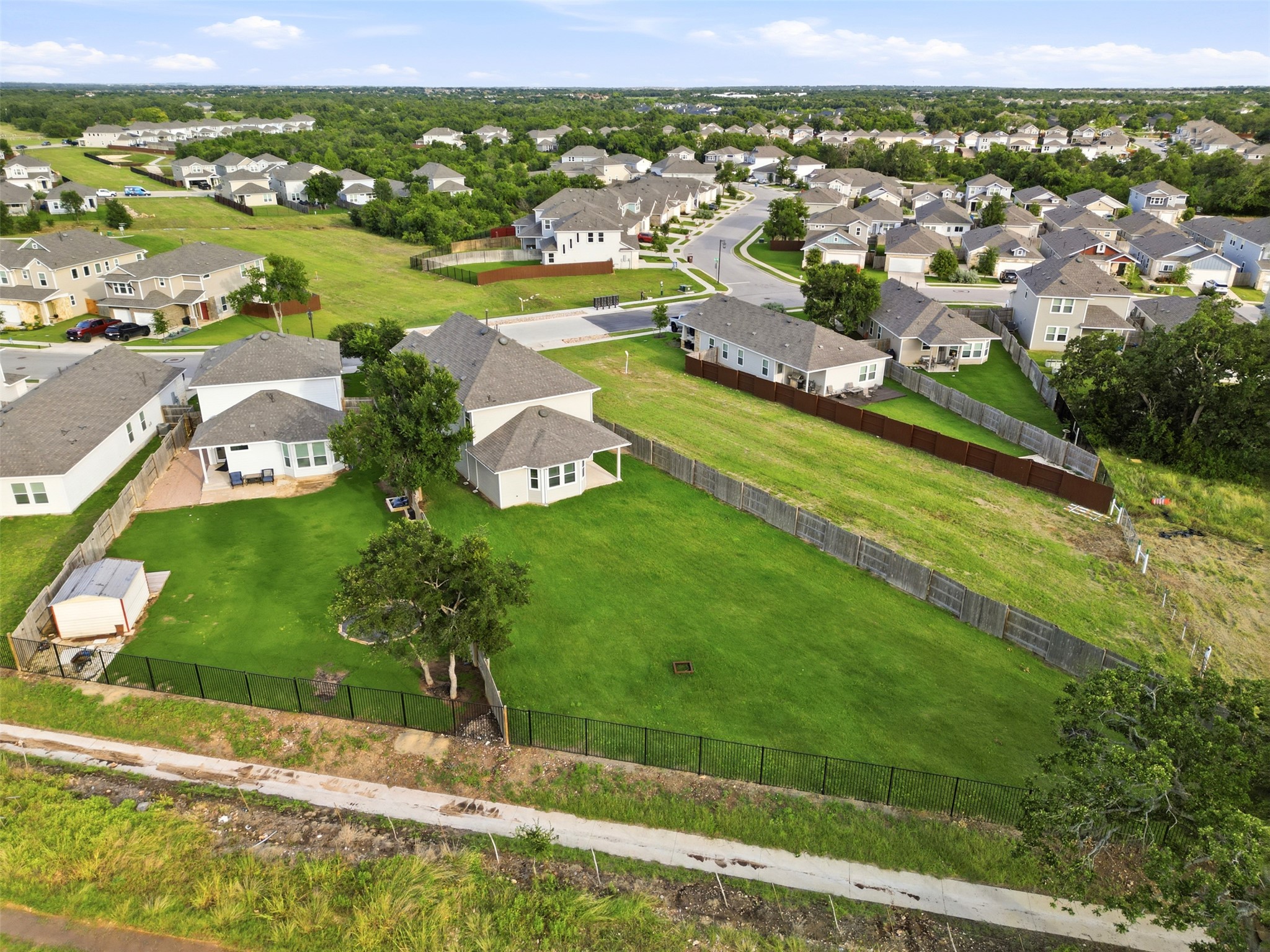 60 Bent Trl Lane Georgetown, TX 78628 - Photo 38 of 40 An aerial perspective showcases a residential neighborhood nestled among verdant trees and ample green space.
