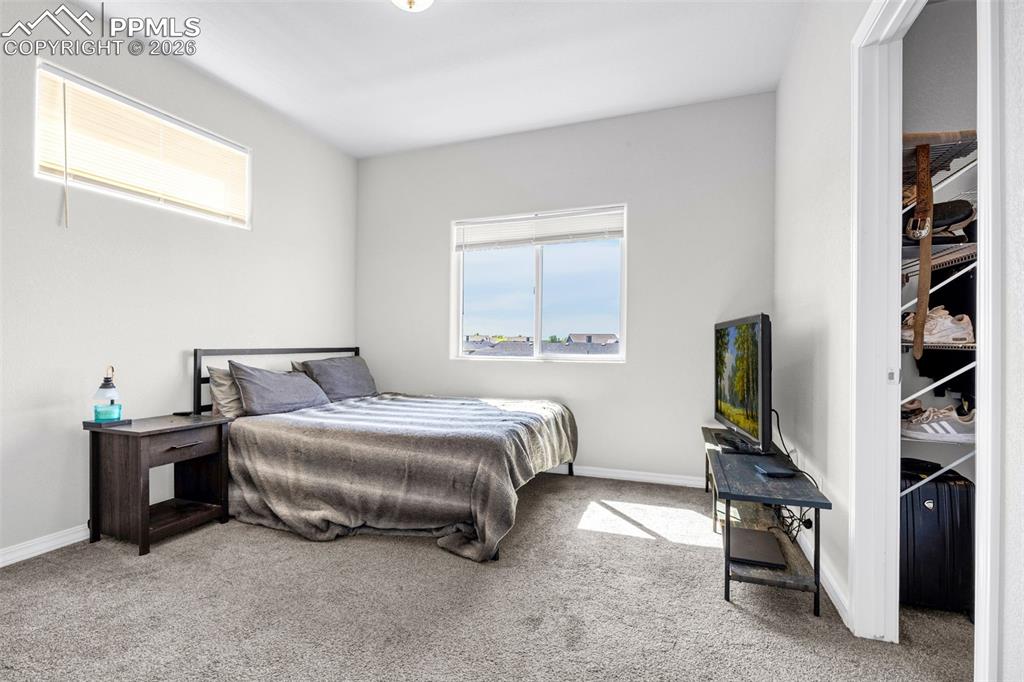 4432 Samaritan Loop Colorado Springs, CO 80916 - Photo 14 of 20 a bedroom with a bed chair and a window