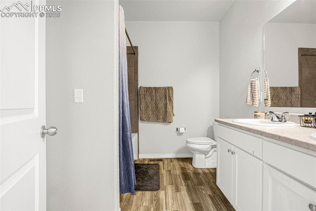 4432 Samaritan Loop Colorado Springs, CO 80916 - Photo 17 of 20 a bathroom with a granite countertop toilet sink and a mirror