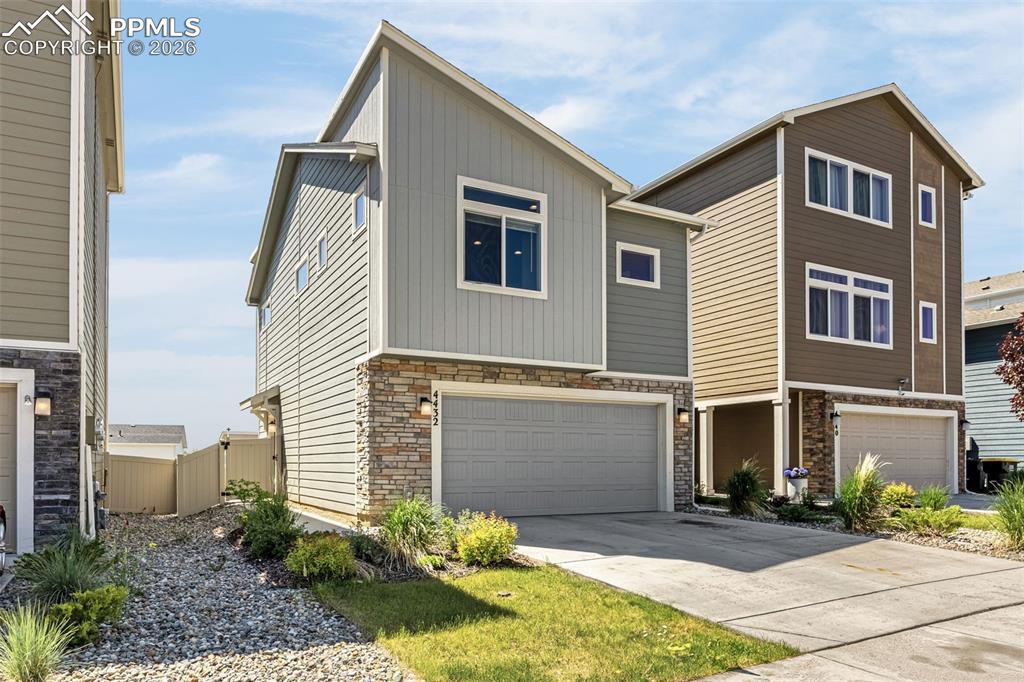 4432 Samaritan Loop Colorado Springs, CO 80916 - Photo 2 of 20 a view of a house with many windows and plants
