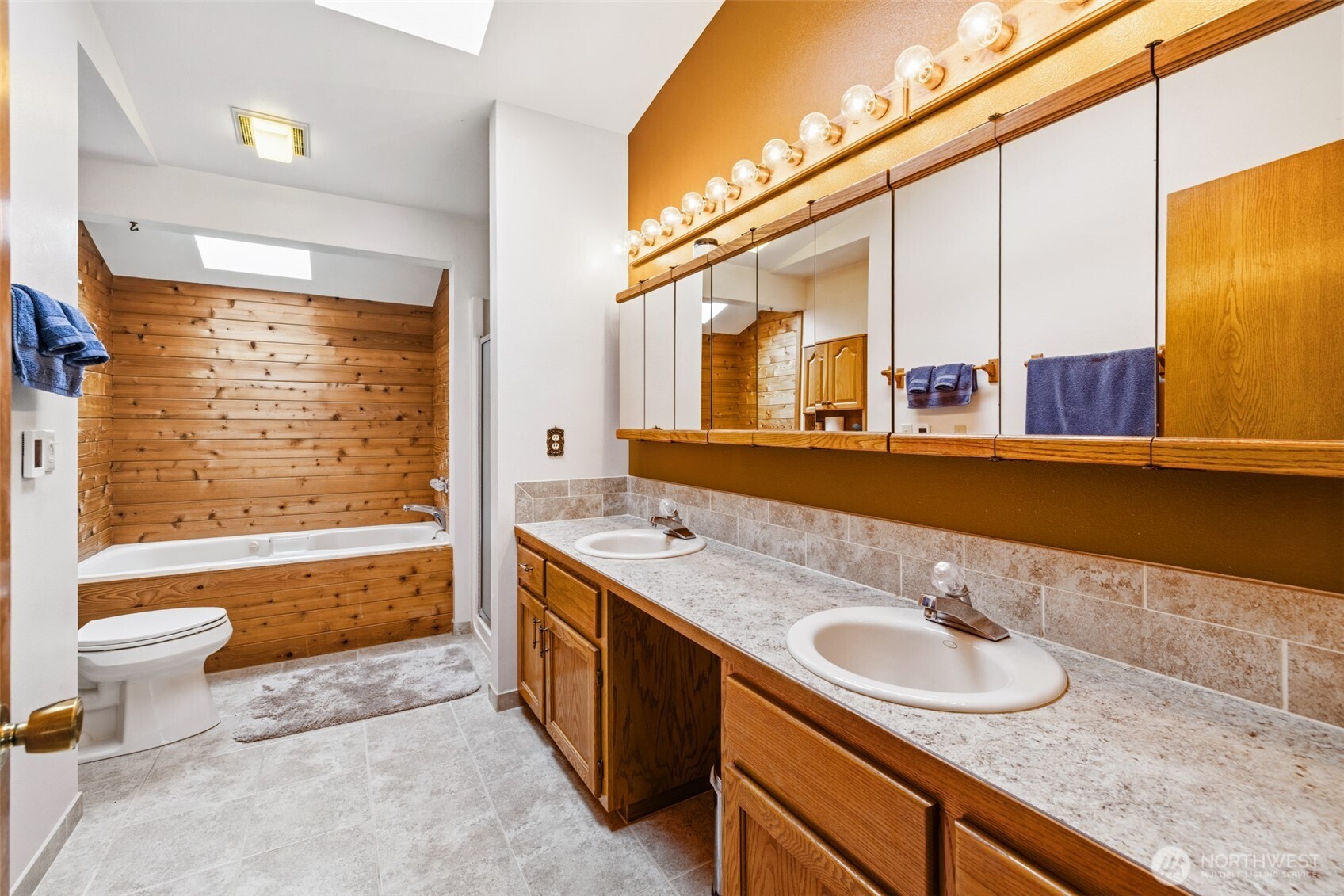 1813 East 3rd Street Port Angeles, WA 98362 - Photo 25 of 40 a bathroom with a granite countertop sink and a bathtub