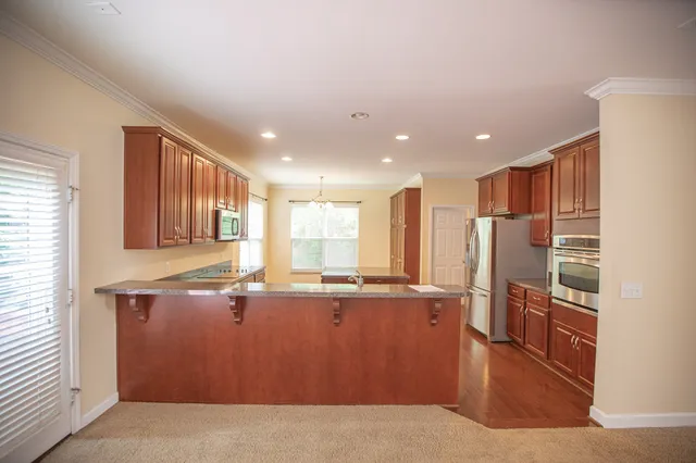 a kitchen with stainless steel appliances granite countertop a stove and a refrigerator