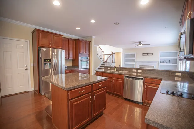 a kitchen with stainless steel appliances granite countertop a sink a microwave cabinets and a counter top space