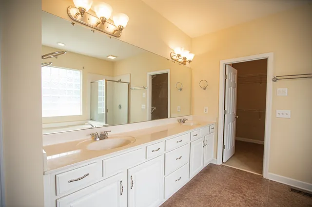 a bathroom with a sink mirror and toilet