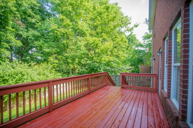 a view of backyard with deck and wooden floor