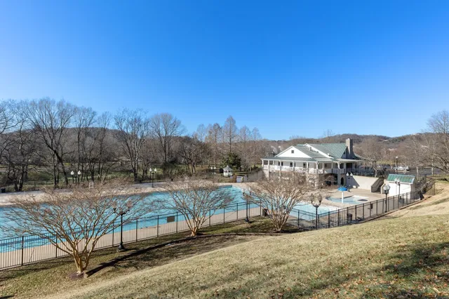 a view of a house with a small yard and potted plants