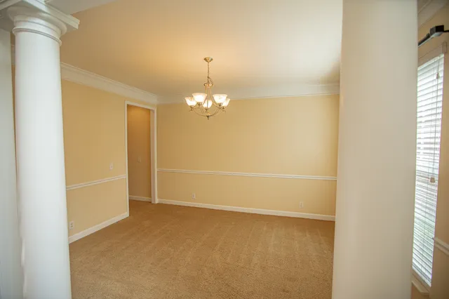a view of a hallway with a wooden door