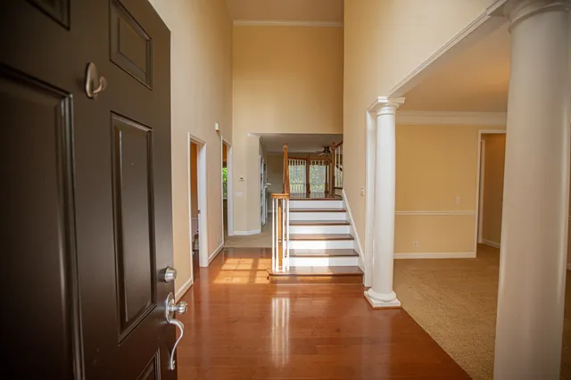 a view of a hallway with entryway wooden floor and front door