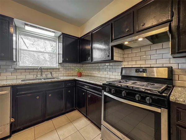 a kitchen with a stove and a sink