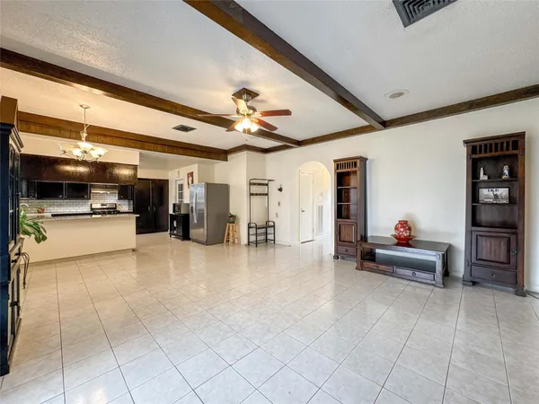 a living room with furniture and kitchen view