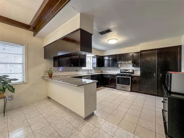 a kitchen with stainless steel appliances kitchen island granite countertop a sink counter top space cabinets and stainless steel appliances