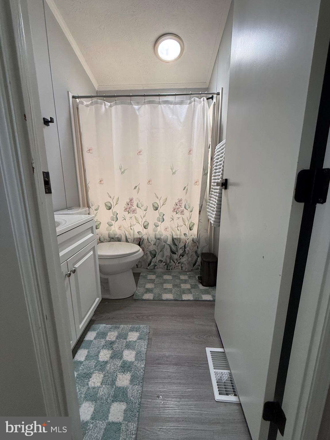 7959 Telegraph Road Severn, MD 21144 - Photo 6 of 18 a bathroom with a sink a toilet and shower