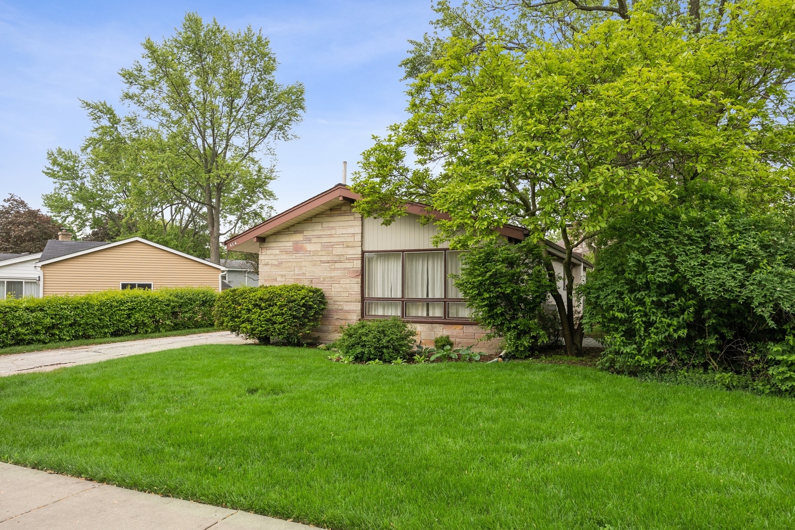 414 Shermer Road Glenview, IL 60025 - Photo 1 of 16 a backyard of a house with plants and large tree