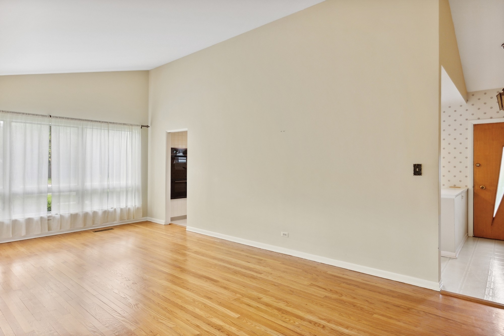 414 Shermer Road Glenview, IL 60025 - Photo 6 of 16 a view of an empty room with wooden floor and a window