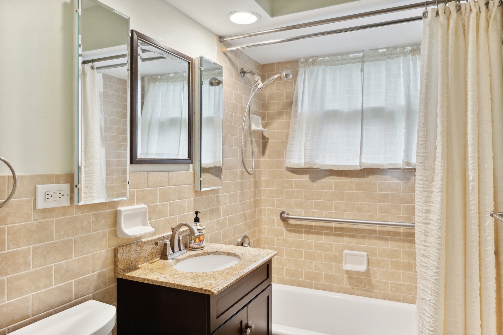 414 Shermer Road Glenview, IL 60025 - Photo 8 of 16 a bathroom with a sink and a mirror