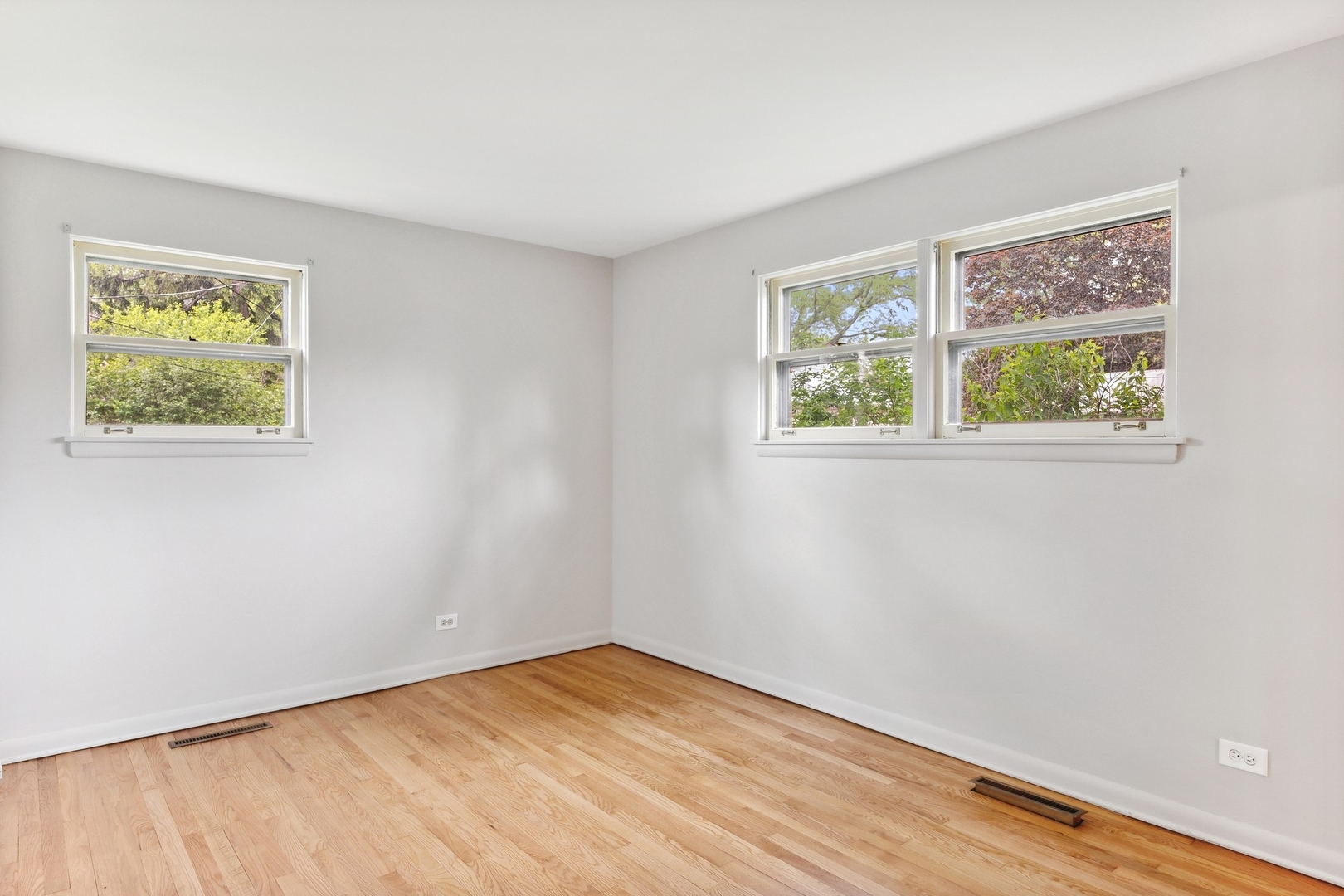 414 Shermer Road Glenview, IL 60025 - Photo 9 of 16 a view of an empty room with wooden floor and a window
