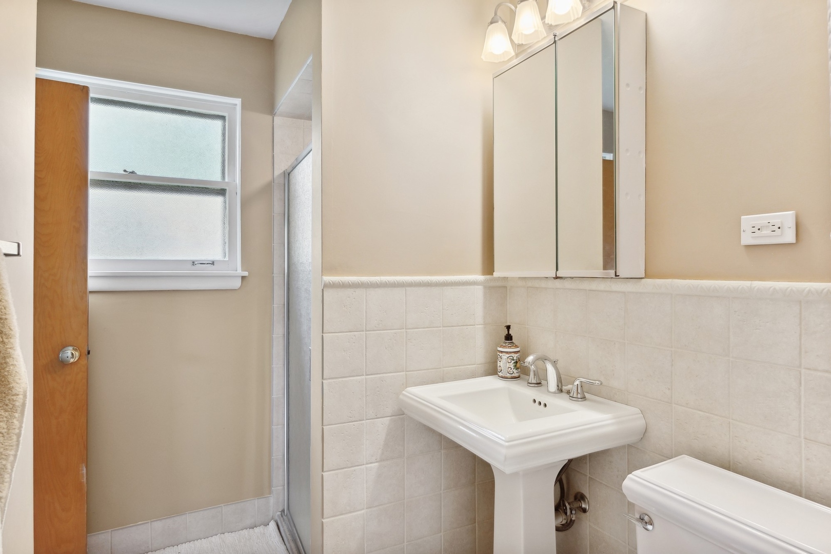 414 Shermer Road Glenview, IL 60025 - Photo 10 of 16 a bathroom with a sink a toilet and a mirror