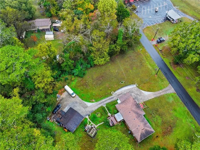 an aerial view of a house with a garden and swimming pool